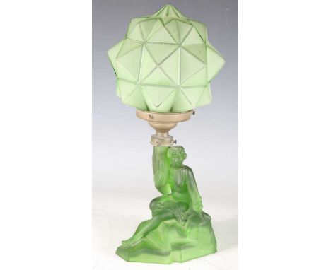 An Art Deco green glass table lamp with faceted shade and figural base, height 39cm.