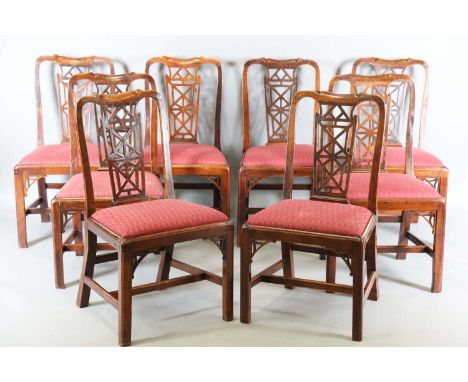 A set of eight George III Chinese Chippendale style fruitwood dining chairs with trellis fretwork backs and drop-in seats, he