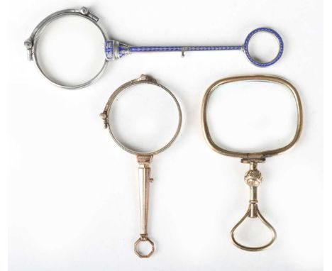 An early 20th century French silver and blue enamelled lorgnette, length 13.7cm, together with a gilt metal lorgnette and a V