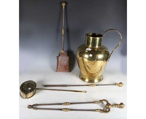 A large 19th century brass flagon, height 45cm, a set of three 19th century brass and steel fire tools, a brass chestnut roas
