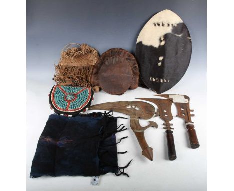 A group of tribal items, including an African Kota Onzil bird head throwing knife, length 41cm, two other knives and a bag wi