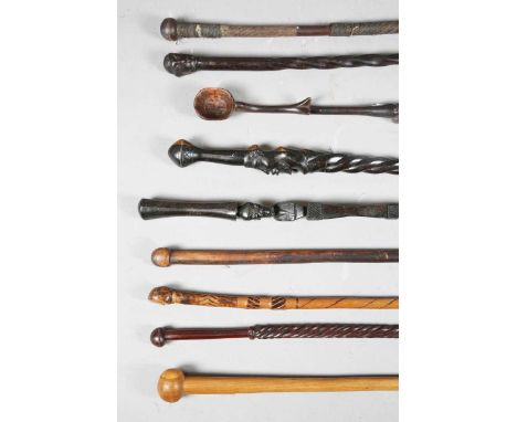 A group of nine African hardwood walking sticks and staffs, including one with ladle handle and swollen belly shaft, length 6