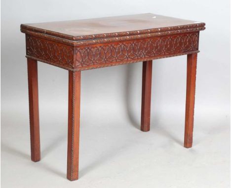 A George III mahogany fold-over card table, the deep frieze carved with blind fretwork, on block legs, height 74cm, width 91c