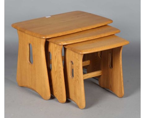A modern Ercol pale elm nest of three occasional tables, height 45cm, width 64cm, depth 41cm.
