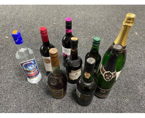 A tray of nine assorted bottles of alcohol; Martel Cognac, Cockburn's Port, Harvey Bristol Cream, vodka and wines 