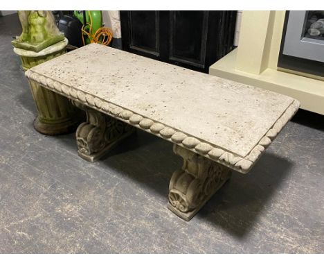 A concrete pedestal garden bench 