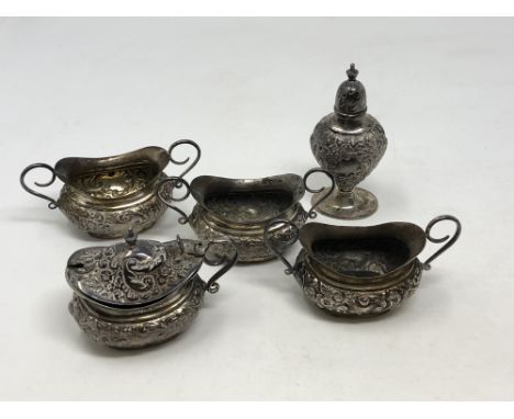 An ornate Victorian five piece silver condiment set, Walker &amp; Hall, Sheffield 1899