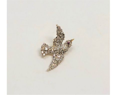 A superb quality antique diamond set swallow brooch with ruby eye, length 28mm