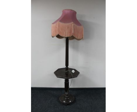 An early 20th century oak standard lamp fitted an octagonal wine table and pink tassel shade 