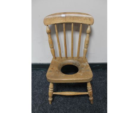 An antique pine child's commode chair 