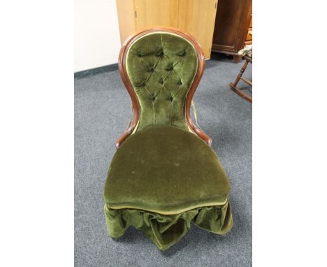 A Victorian mahogany framed lady's chair upholstered in a green button dralon 