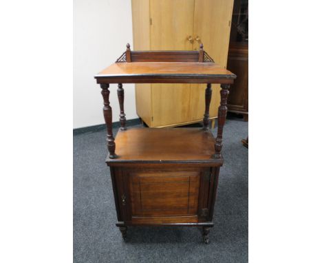 An Edwardian mahogany cabinet fitted shelf above, on ceramic castors 