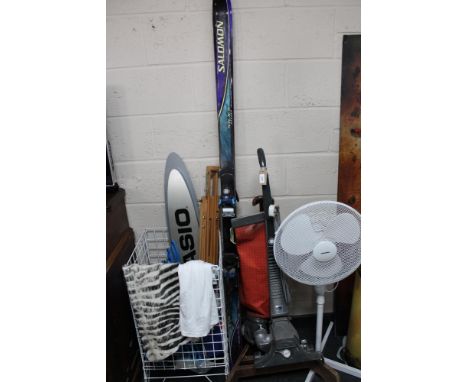 A Kirby Heritage upright vacuum cleaner, standing fan, pair of Salomon skis and basket of coat hangers, artist's easel, Casio