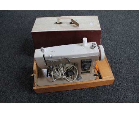 A mid 20th century New Home sewing machine and a gilt framed tapestry firescreen 