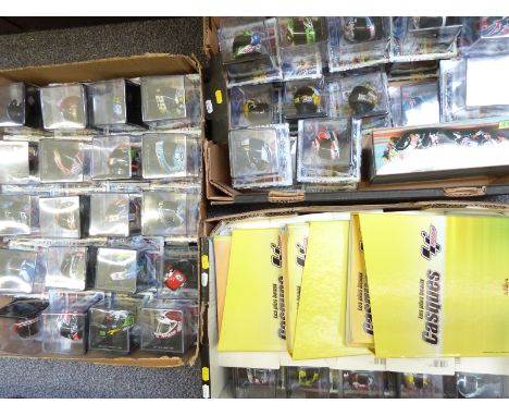 Eighty-six Altaya diecast model Moto GP motorbike helmets, all in original display boxes with related magazines together with