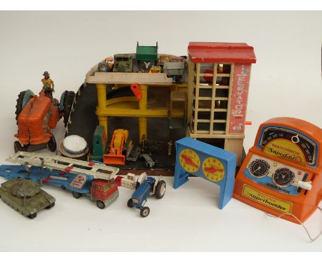 A collection of Corgi, Dinky and similar diecast model vehicles together with a wooden and plastic car garage, battery powere