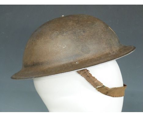 British Army WWII 'Brodie' steel helmet with liner and chin strap, the rim stamped 1939
