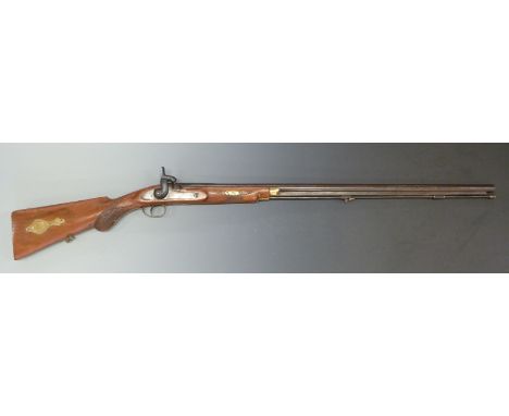 Muzzle loading percussion hammer action gun with chequered semi-pistol grip and forend, brass trigger guard, mounts and stora