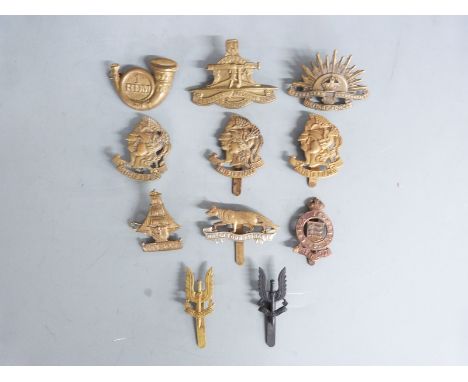 A small collection of British Army and other cap badges including Artist's Rifles and Special Air Service