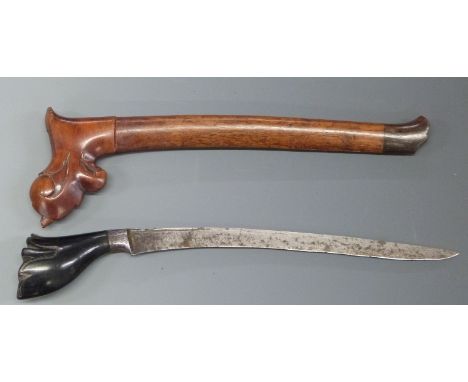 A Polynesian / Kris style dagger with 22cm blade, in carved wooden scabbard.&nbsp;