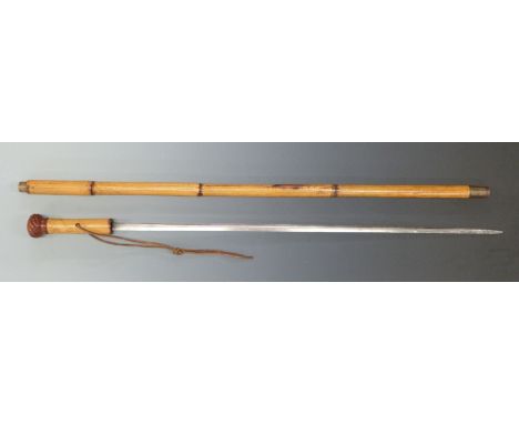 A 19thC bamboo sword stick with carved knop, brass end and collar and a 65cm blade.&nbsp;