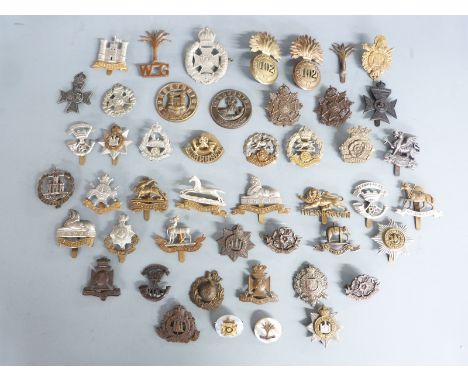 A collection of British Army cap badges, mainly Infantry regiments including The Queen's Regiment, Somerset, Dorsetshire etc