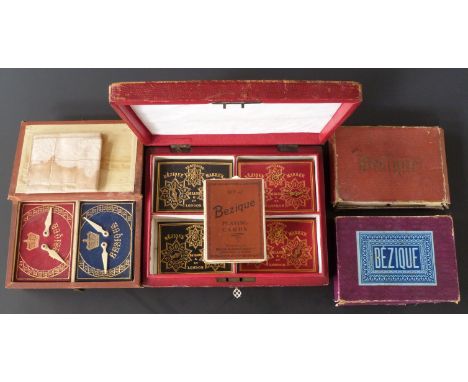 Five cased / boxed Bezique playing card sets including De La Rue leather cased set with markers