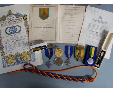 A collection of Dutch Army memorabilia from WWII relating to Hijman Roet. Includes a cap badge for Princess Irene, who became