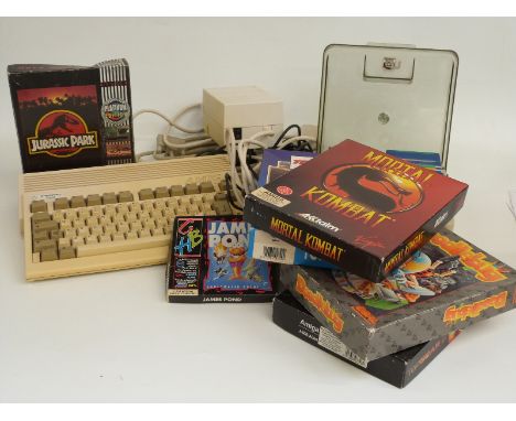 Commodore A600 Amiga games console together with joystick and various games including Mortal Kombat, Top Gear 2, Jurassic Par