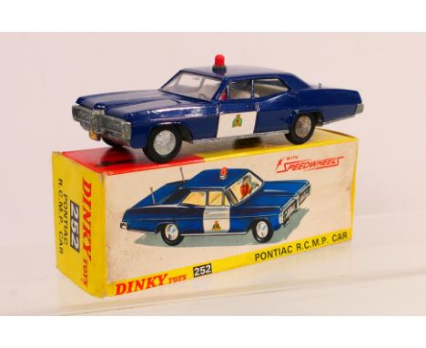 Dinky Toys - A boxed Dinky Toys #252 Pontiac 'Royal Canadian Mounted Police' Car. The model with dark blue body, white door p