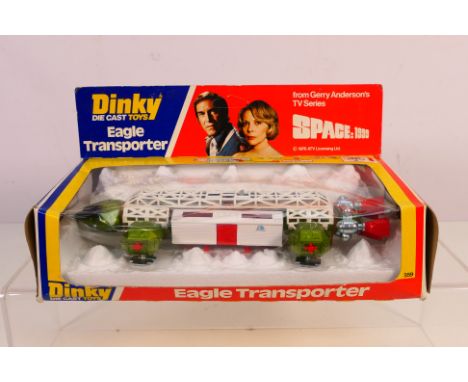 Dinky Toys - A boxed Dinky Toys #359 'Space 1999' Eagle Transporter. The model in white and green with red rear and side thru