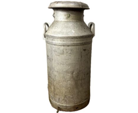 A vintage milk churn, inscribed C W S Ltd Milk Group and stamped Swiftcan&nbsp;