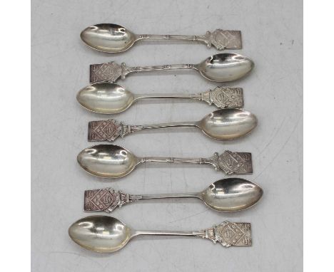 A matched set of seven Elizabeth II silver teaspoons, each having a shield shaped finial, each having been awarded for a diff