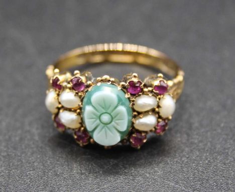 A vintage 15ct gold carved jadeite, seed pearl and garnet set ring, the jadeite having a flower head carving, 2g, size M