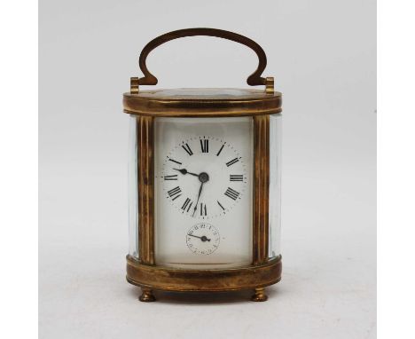 A brass cased carriage clock, the enamel dial showing Roman numerals with subsidiary seconds dial, having a visible platform 