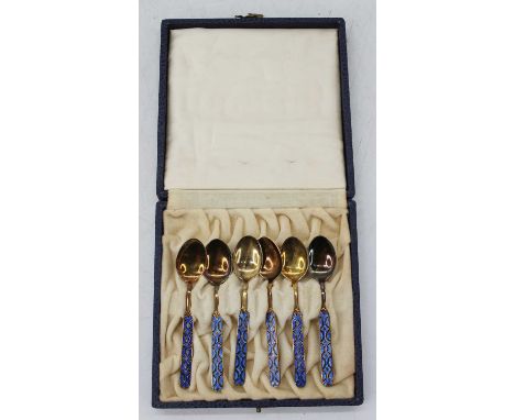 A cased set of six Norwegian silver gilt coffee spoons, each having an enamelled terminal with fleur de lys decoration, weigh