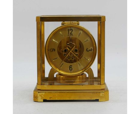 A Jaeger le Coultre Atmos clock, housed in a gilt brass and glazed case, the chapter ring stamped Le Coultre, height 34cm (a/