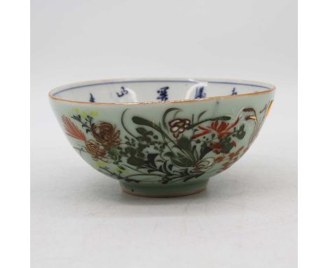 A Chinese celadon glazed bowl, enamel decorated with flowers, seal mark to the underside, dia. 16.5cm Large firing crack from