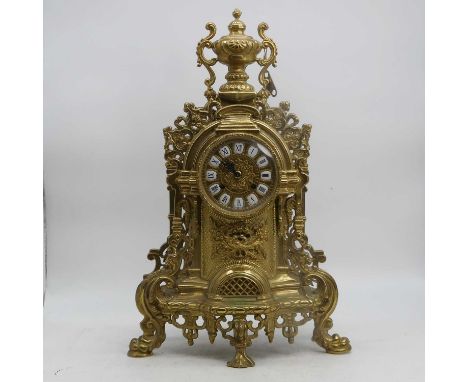 A 20th century brass cased mantel clock, the chapter ring with enamel roman numeral cartouches, having an 8-day movement, hei