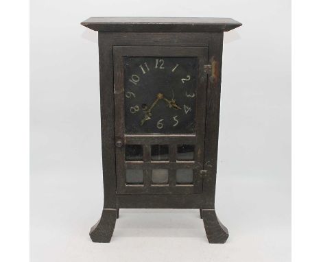 An early 20th century oak cased mantel clock, the dial showing Arabic numerals, the 8-day movement striking on a gong, height