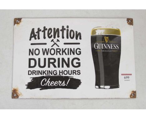 An enamel sign inscribed 'Guinness - Attention no working during drinking hours', 20 x 30cm
