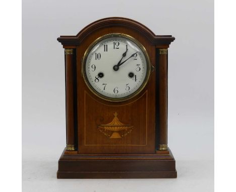 An early 20th century mahogany and boxwood strung cased mantel clock, the enamel dial showing Arabic numerals, the eight day 