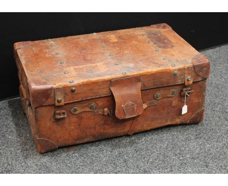 An early 20th century brown leather travelling trunk, brass studded lid, 84cm wide, monogrammed EG (this was the property of 
