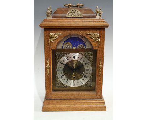A George III style oak cased 'bracket' clock, 16cm arched dial with moonphase, silvered chapter ring, Roman numerals, 50cm hi