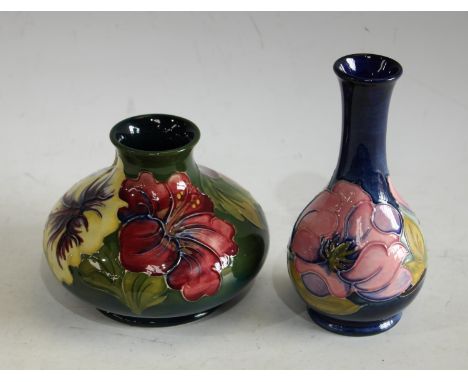 A Moorcroft Hibiscus pattern compressed ovoid vase, tube lined with purple/pink and yellow flowers on a green ground, 11cm, i