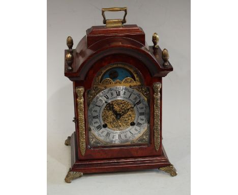 A Franz Hermle burr walnut bracket clock, the arched dial with sun moon phase, silvered chapter ring, Roman and Arabic numera