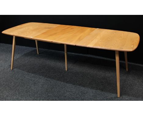 An Ercol elm extending dining table, rounded rectangular top with additional hinged leaf, tapered square outswept legs, exten