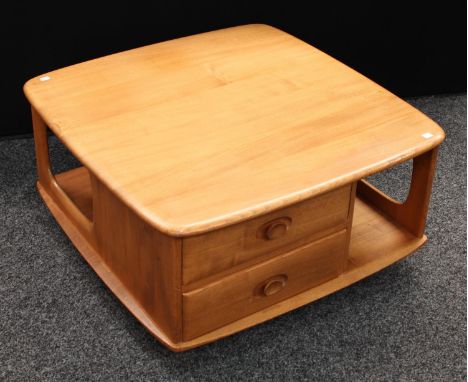 An Ercol elm coffee table, rounded square top above two short drawers and an arrangement of open book provisions, casters, 40