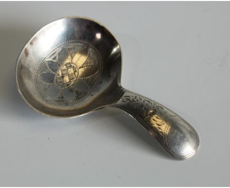 An Edwardian silver caddy spoon, of George III design, engraved overall with wrigglework, Sheffield 1911