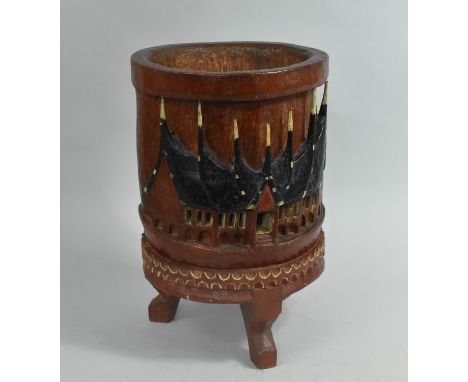 A Circular Carved Planter on Tripod Stand formed from a Section of Palm Tree and Decorated with Tribal Longhouse, 39cms High 